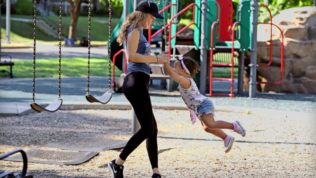 People enjoying the swings and slides at Brookside Park