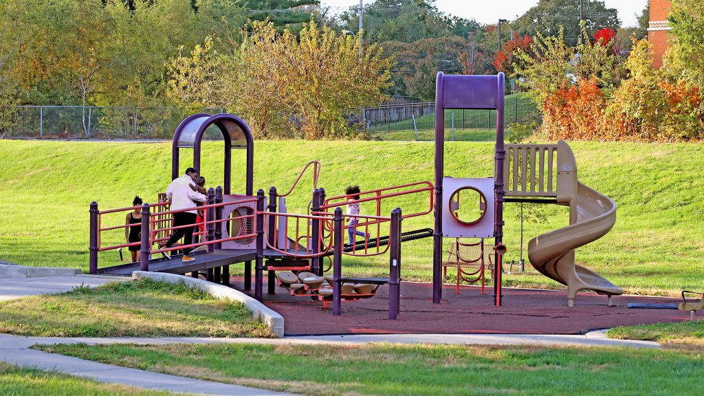 Kids playing on the slides in a park in Fall