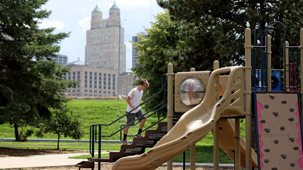 Kid climbing the Stairs to get to the slide